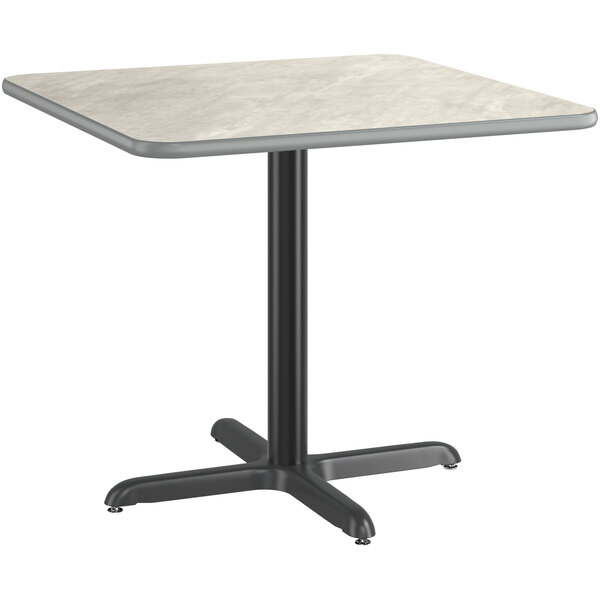 A white and slate gray Lancaster Table & Seating square table top on a white metal base.