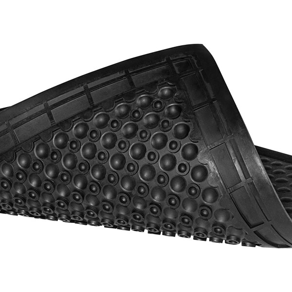 A black rubber Notrax Skystep ESD floor mat with holes in it.
