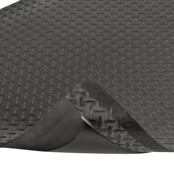 A black rubber Notrax Dura Trax Grande anti-fatigue mat with a curled corner.