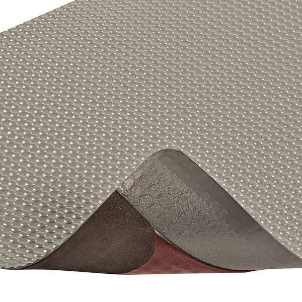 A close-up of a gray Notrax Bubble Trax anti-fatigue mat.