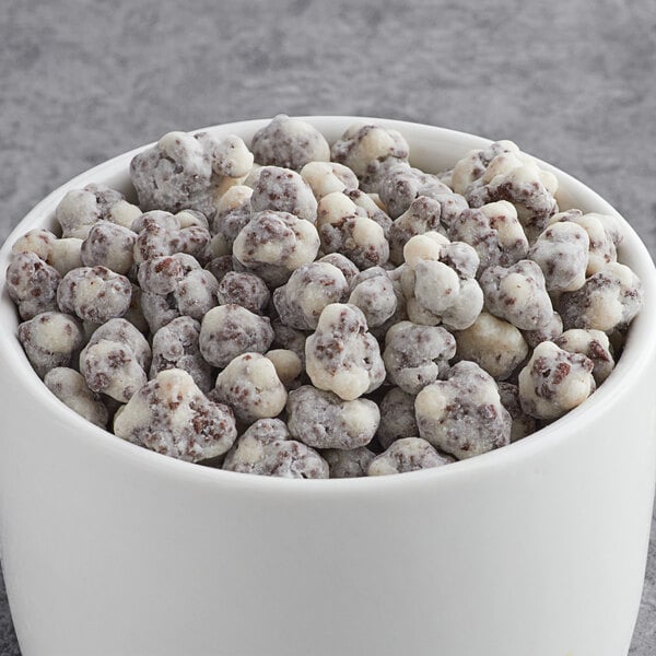 A bowl of white and brown cookies and cream clusters.