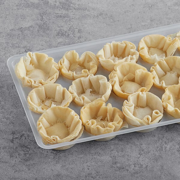 A tray of Fillo Factory mini pastry shells on a gray surface.