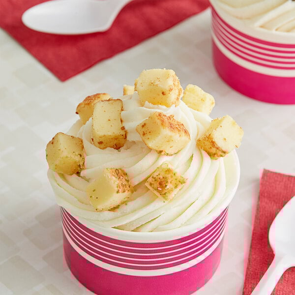 A close up of a yellow and white cake piece.