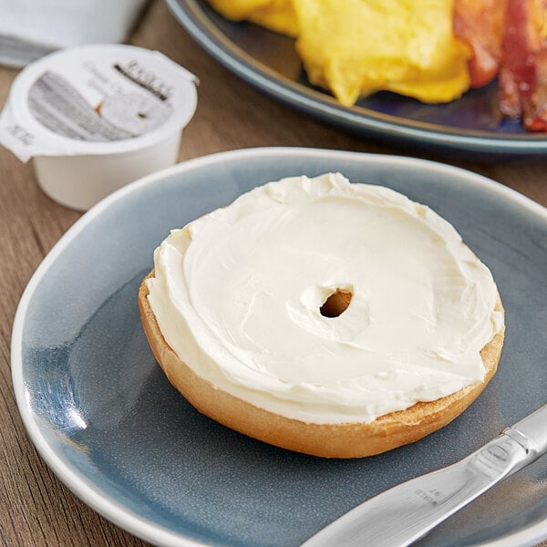 A bagel with Raskas cream cheese on a plate.