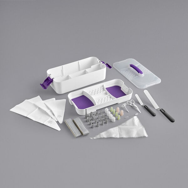 A Wilton cake decorating set in a white and purple plastic case.