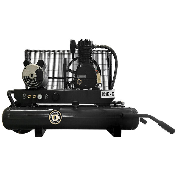 An Industrial Gold wheel barrow style air compressor with a metal cage.