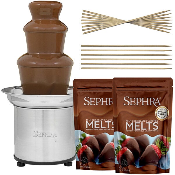 A Sephra chocolate fountain with milk chocolate, bamboo skewers, and strawberries.