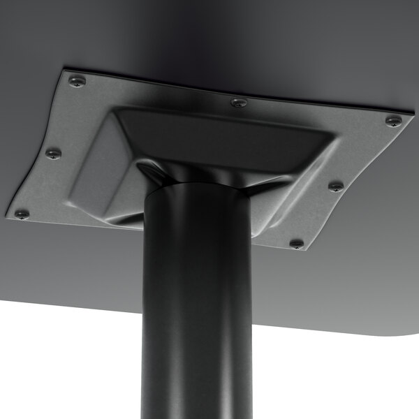 A close-up of Lancaster Table & Seating black bar height column table base with leveling feet.