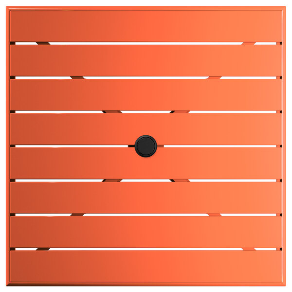 An orange square table with a black umbrella hole.