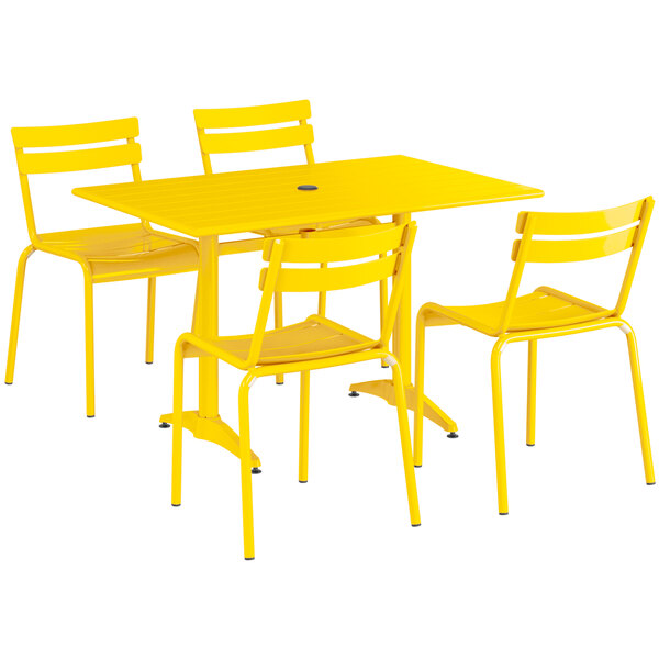A yellow Lancaster Table & Seating outdoor table and chairs set.