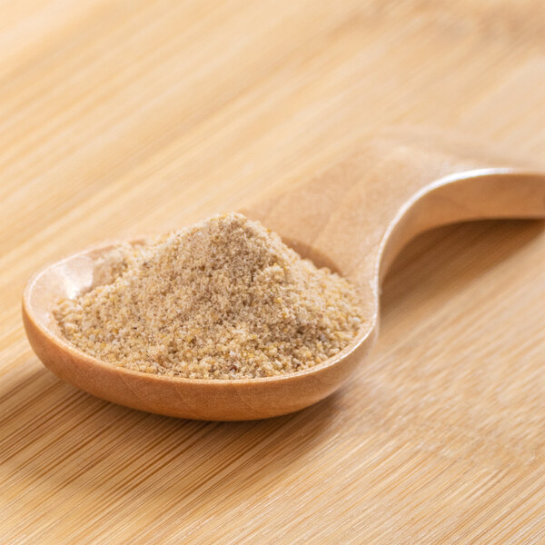 A wooden spoon with date powder on it.