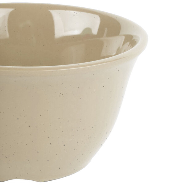 A close-up of a GET Tahoe Sandstone bowl with a speckled design.