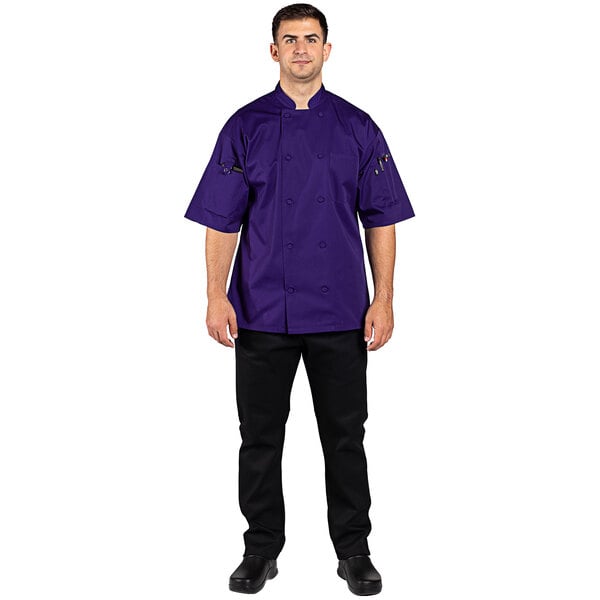 A man wearing a grape-colored Uncommon Chef short sleeve chef coat.