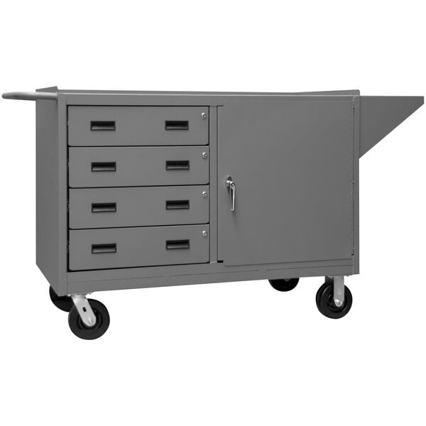 A grey metal cart with black wheels and one door.