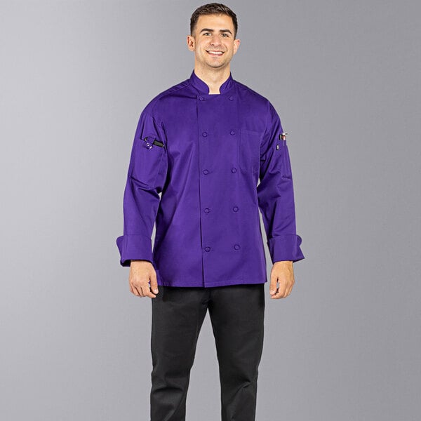 A man wearing a grape Uncommon Chef long sleeve chef coat.