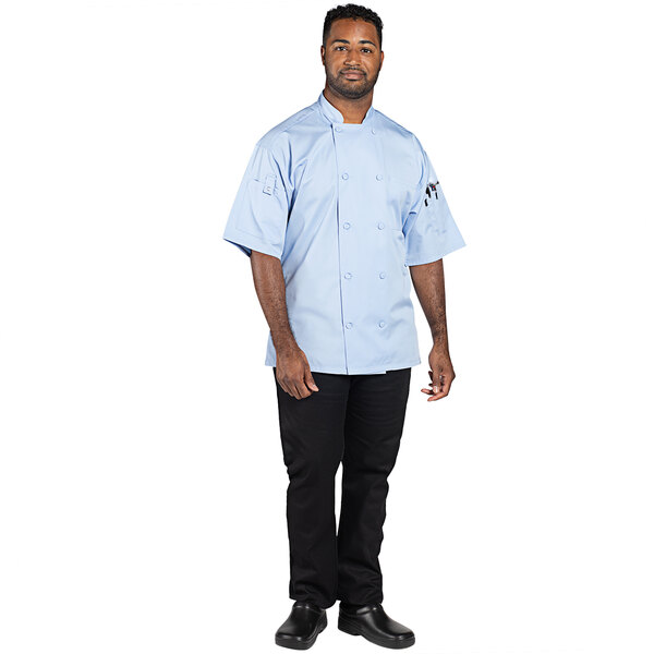 A man wearing an Uncommon Chef sky blue short sleeve chef coat.