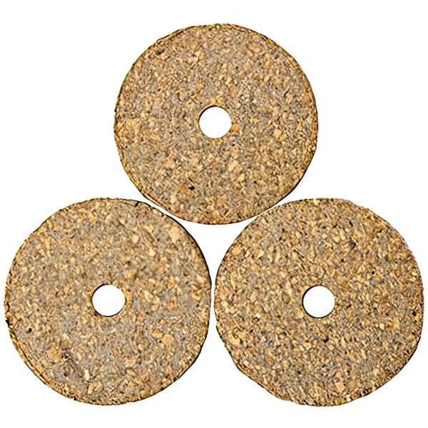 Three round brown cork gaskets with holes in them.