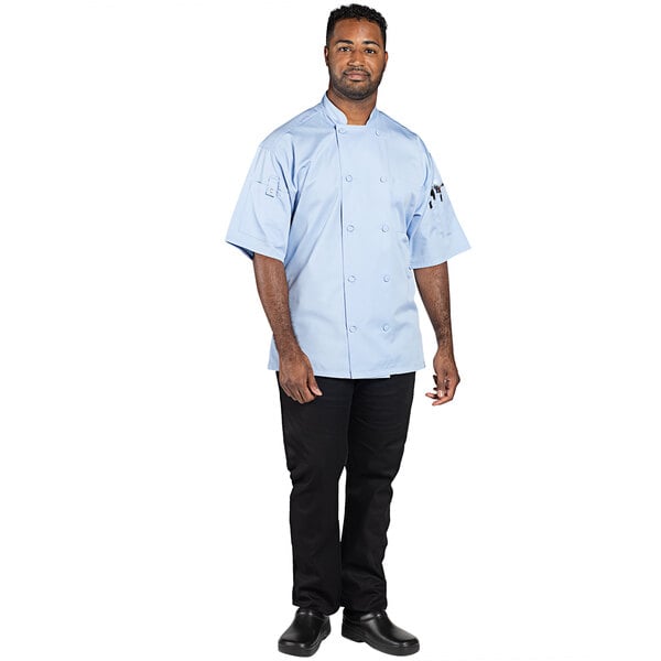 A man wearing a sky blue short sleeve chef coat.