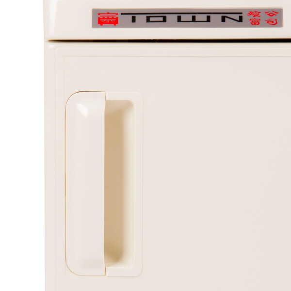 A white Town towel steamer machine.