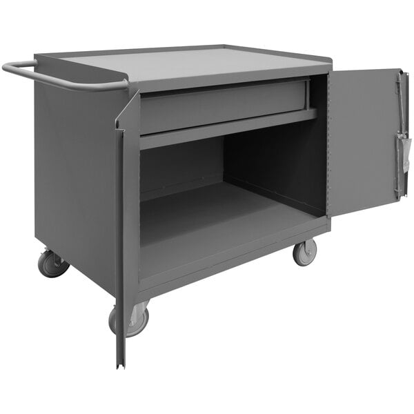 A gray Durham Mobile Steel Top Workstation cart with a door and drawer open.