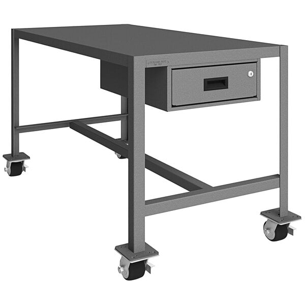 A grey metal Durham machine table with wheels.