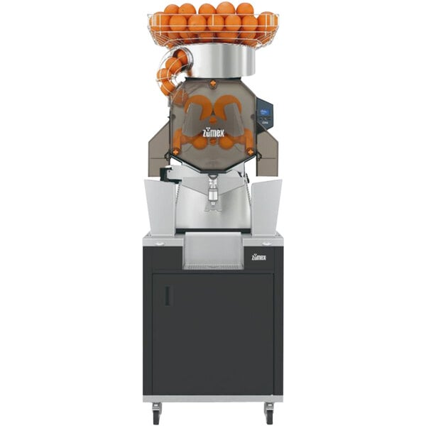 A Zumex Speed S+ juicer with oranges in a basket on top.