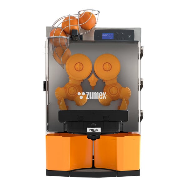 A white Zumex Essential Pro juicer with oranges in the feed basket.