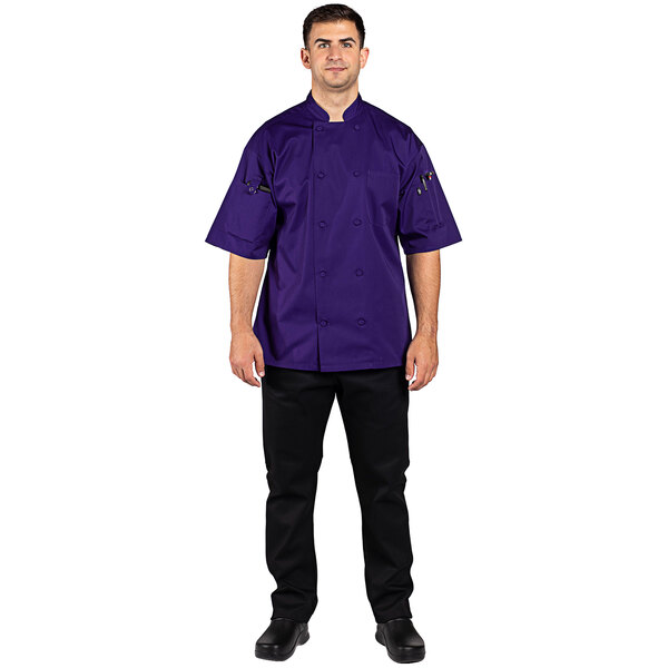 A man wearing a grape Uncommon Chef short sleeve chef coat.