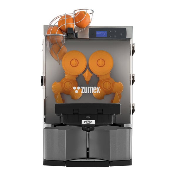 A Zumex Essential Pro juicer with an orange in the automatic feed.