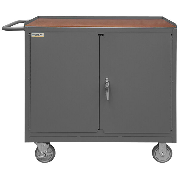 A gray Durham Mfg workstation with a brown hardboard top and doors.