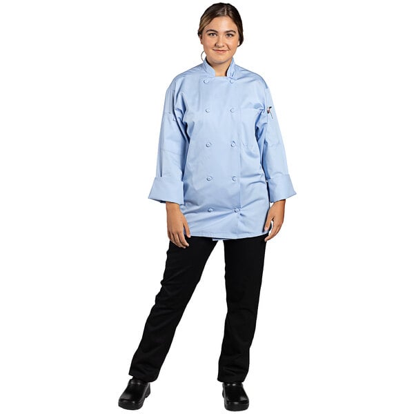 A woman wearing a sky blue long sleeve chef coat.