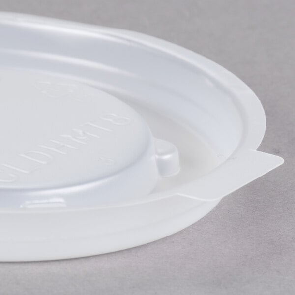 A translucent white plastic Cambro lid with text on it.