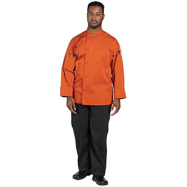 A man wearing an Uncommon Chef orange long sleeve chef coat.