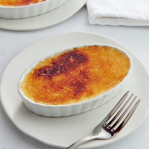 A white dish with White Toque Creme Brulee on it.