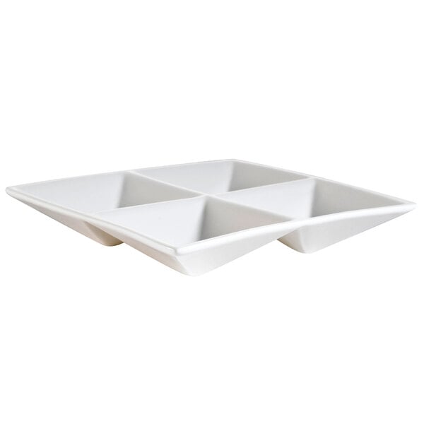 A bone white square porcelain dish with 4 compartments.