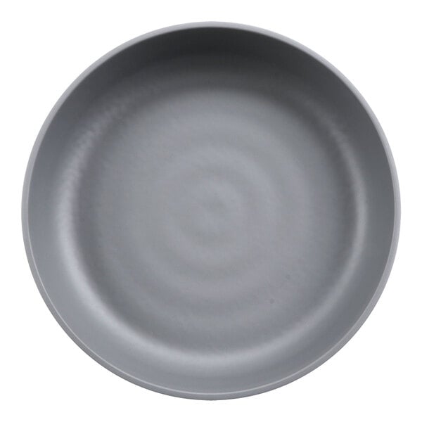 A close-up of a grey bowl with a circular design in the middle.