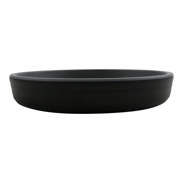A round, shallow, matte black plate with a smooth finish, viewed from the side.
