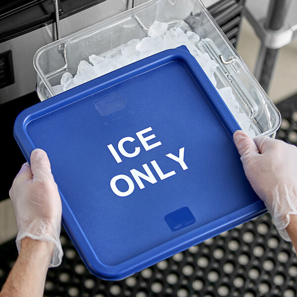 A person using a blue Vigor ice tote to transport ice.