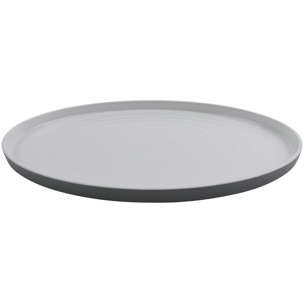 A white oval melamine platter with a black border.