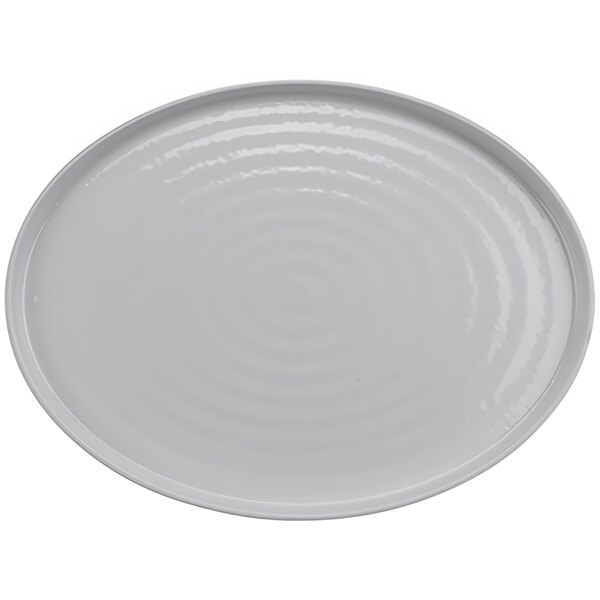 A white oval platter with a circular pattern on the surface.