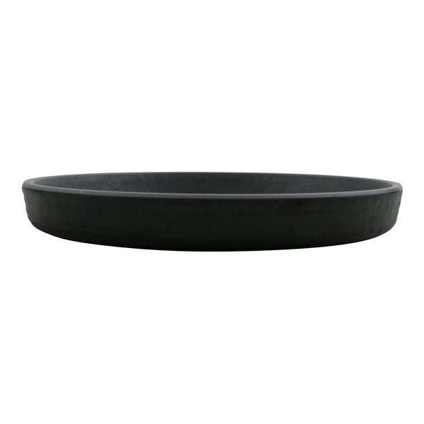 A round, shallow, matte black and gray plate with a smooth finish, viewed from the side.