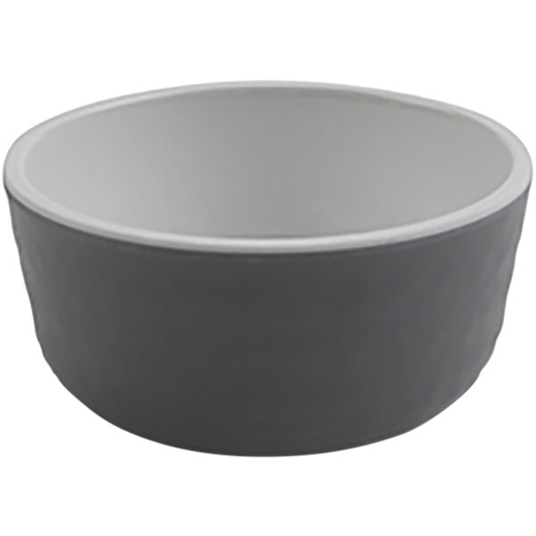 A grey melamine sauce dish with a white rim.