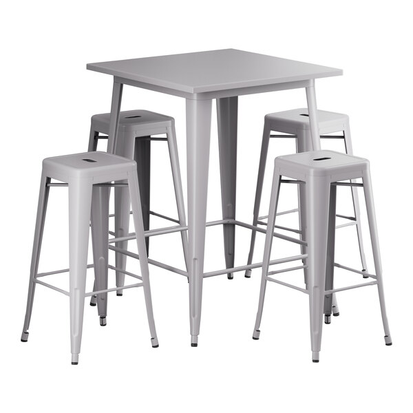 A Lancaster Table & Seating nickel gray metal bar height table with four stools.