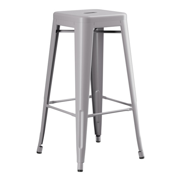 A gray Lancaster Table & Seating barstool with a black seat.