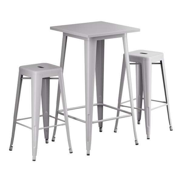 A Lancaster Table & Seating nickel gray bar height table with two backless stools.