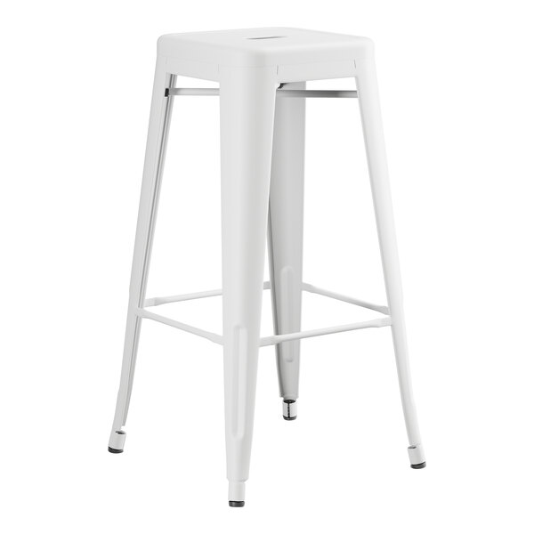 A Lancaster Table & Seating pearl white metal bar height table with 2 backless barstools.