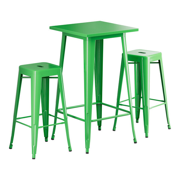 A jade green table with two backless barstools.