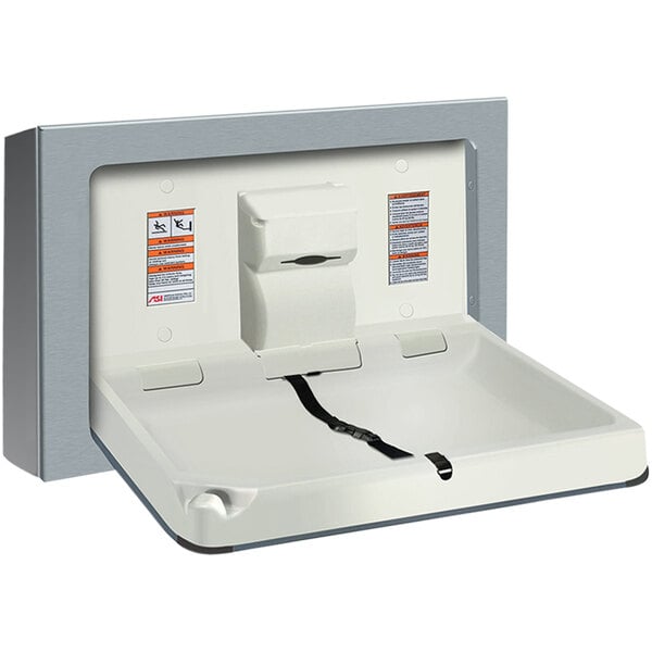 A stainless steel rectangular object with a seat open on a wall.