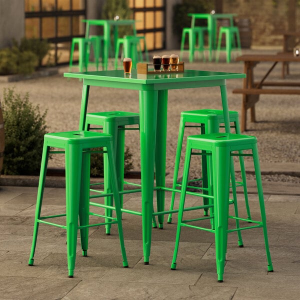 A Lancaster Table & Seating jade green bar table with four backless barstools.