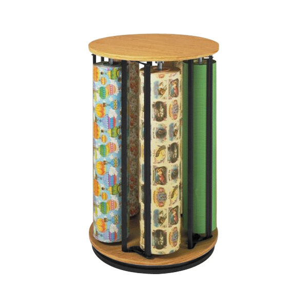 A Bulman oak Suzy rack holding 5 rolls of wrapping paper on a round wooden stand.